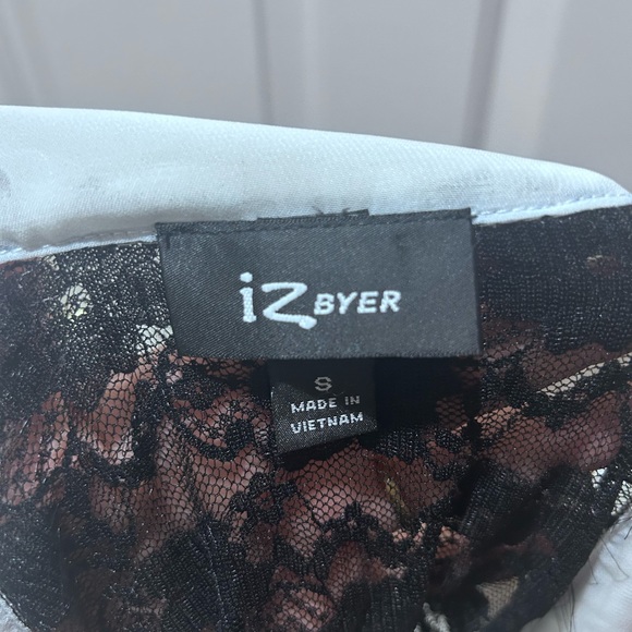 White formal top with ruffles on front and black lace back. - Picture 3 of 3